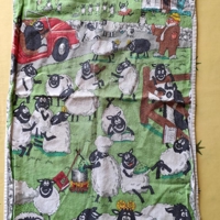 Tea towel illustrating sheeple on holiday in Devon.