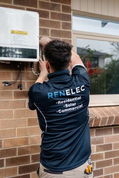 Professional electrician Unley performing electrical installation and wiring work on switchboards with advanced surge protection and high voltage safety equipment.