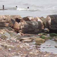 Damage to the wall that protects the outflow from the Dawlish Brook to the sea.